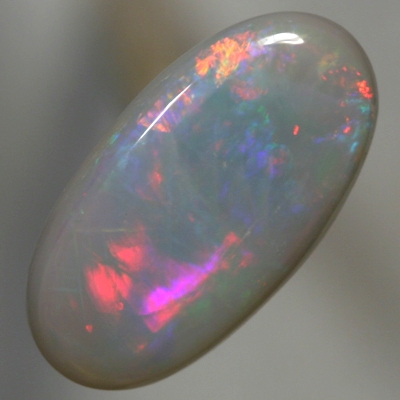 SOLID SEMI BLACK OPAL Rolling flashes of red and neon orange to magenta and purple
